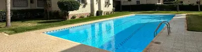 a blue swimming pool in front of a house at Residence Luxueuse avec 2 Piscines à Harhoura Temara proximité plages princesses & Sables d'Or in El Harhoura