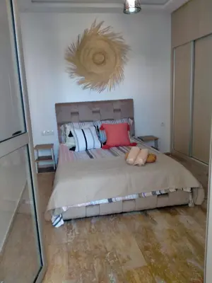 a bedroom with a bed with two stuffed animals on it at heaven beach sidi rehal in Sidi Rahal