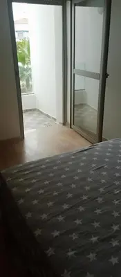 a bedroom with a bed and a glass door at heaven beach sidi rehal in Sidi Rahal