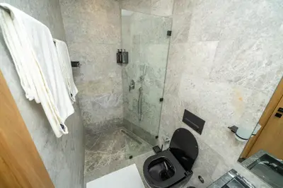 a bathroom with a toilet and a glass shower at Twenty Four Inn 302 in Casablanca