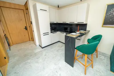 a kitchen with a black counter and a green chair at Twenty Four Inn 304 in Casablanca