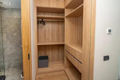 a closet with wooden shelves in a bathroom at Twenty Four Inn 303 in Casablanca