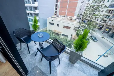 a balcony with two tables and chairs and a window at Twenty Four Inn 303 in Casablanca