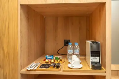a small cabinet with a phone and food and water at Twenty Four Inn 305 in Casablanca