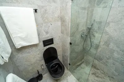 a bathroom with a toilet and a glass shower at Twenty Four Inn 305 in Casablanca