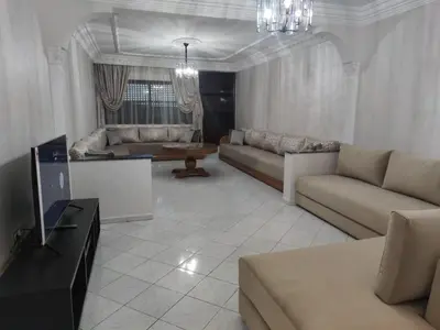a living room with a couch and a tv at Appartement de standing in Casablanca