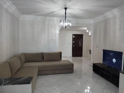 a living room with a couch and a flat screen tv at Appartement de standing in Casablanca
