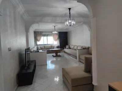 a living room with a couch and a tv at Appartement de standing in Casablanca