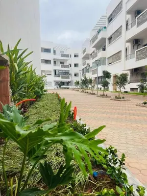 a courtyard of an apartment building with plants and buildings at Bel Appartement à mimosa mohammedia in Mohammedia
