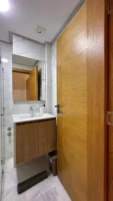 a bathroom with a sink and a wooden door at Chic Family Place - by AppartAli in Casablanca