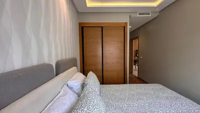 a bedroom with a bed and a wooden door at Chic Family Place - by AppartAli in Casablanca