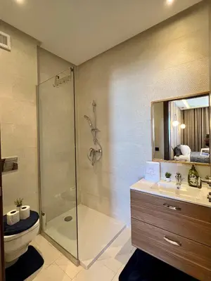 a bathroom with a shower and a toilet and a sink at Casa Financial City 2 Bedrooms - Appartali Luxury Platform in Casablanca