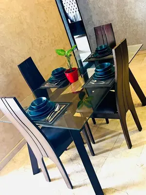 a glass table with chairs and a plant on it at Ocean Apartments in Casablanca