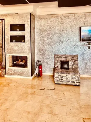 a living room with a couch and a fireplace at Ocean Apartments in Casablanca
