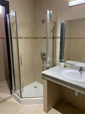 a bathroom with a shower and a sink at Villa pied dans l'eau skhirat in Skhirat