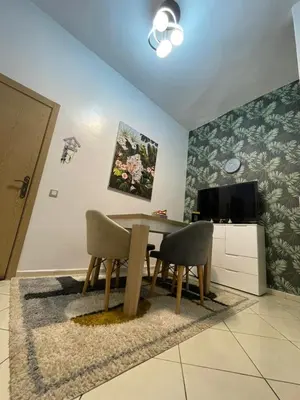 a dining room with a table and two chairs at Chez vous à Skhirate in Skhirat