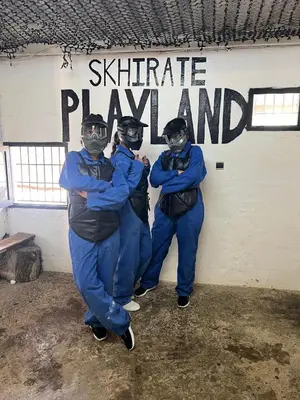 a group of three men standing in front of a sign at Chez vous à Skhirate in Skhirat