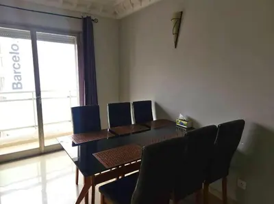a dining room with a table and chairs and a window at Elegant appartement de 2 chambres sur bd Anfa in Casablanca