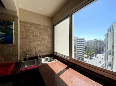 a kitchen with a sink and a large window at Elegant appartement de 2 chambres sur bd Anfa in Casablanca