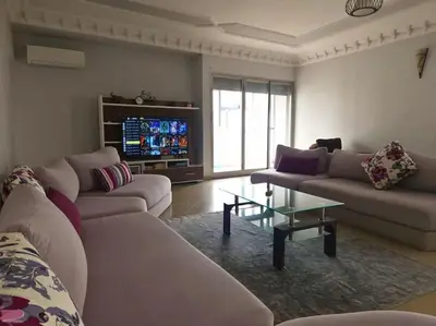 a living room with two couches and a tv at Elegant appartement de 2 chambres sur bd Anfa in Casablanca