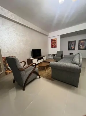 a living room with two chairs and a couch at Appartement de Luxe à Bahia Golf Beach Spacieux de 126 m in Bouznika