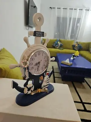 a toy clock sitting on top of a table at Appartement charmant à 5 min de la plage in Skhirat