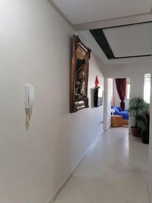 a hallway with a phone on a white wall at Studio Avenue de France in Rabat