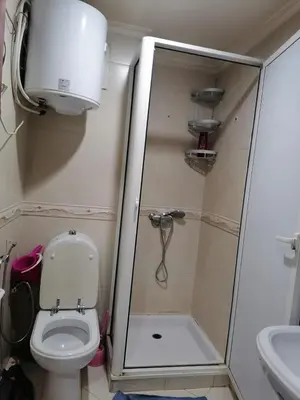 a small bathroom with a toilet and a shower at Studio Avenue de France in Rabat