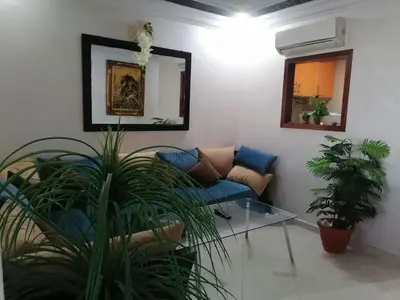 a living room with a couch and a mirror at Studio Avenue de France in Rabat