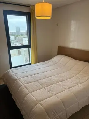 a bedroom with a bed with a large window at Appartement Casa Finance City in Casablanca