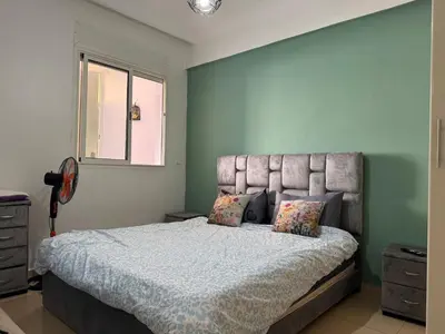 a bedroom with a large bed and a window at Garsoniere Borj in Rabat