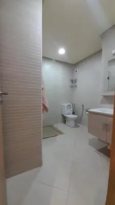 a bathroom with a toilet and a sink at Rayyan Appartement in Bouznika