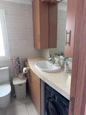 a bathroom with a sink and a washing machine at Appartement 2 Chambres in Sidi Rahal