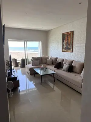 a living room with a couch and a table at Appartement 2 Chambres in Sidi Rahal