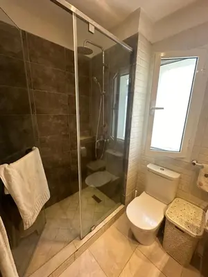 a bathroom with a toilet and a glass shower at Appartement 2 Chambres in Sidi Rahal