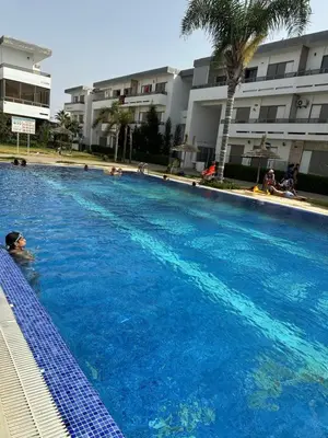 a person swimming in a large swimming pool at Marbella beach el mansouria in Mansouria