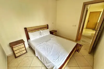 a bedroom with a bed and a door to a hallway at Séjour confortable, Plage Skhirat in Skhirat