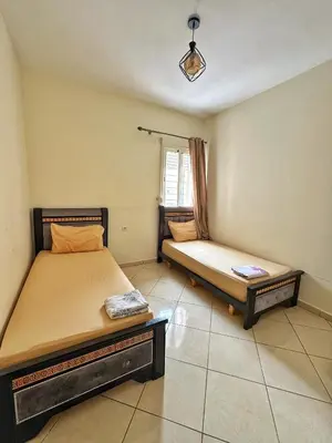 a bedroom with two beds and a window at Séjour confortable, Plage Skhirat in Skhirat