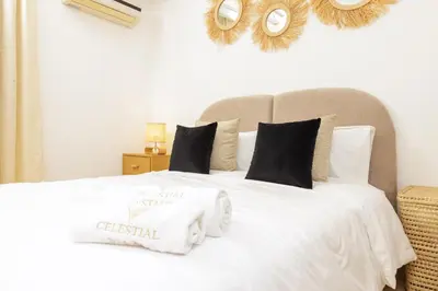 a white bed with a christmas sign on it at Luxury 1BR with Charming Balcony - Romantic Getaway in Rabat