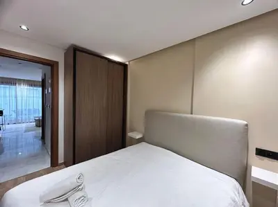 a bedroom with a large white bed with a mirror at Oasis 9 Cozy studio in Downtown Maarif in Casablanca