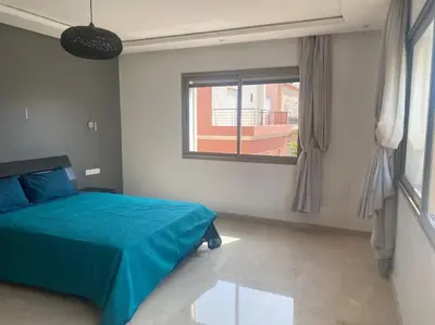 a bedroom with a blue bed and a window at Villa avec piscine Mohammedia in Mohammedia