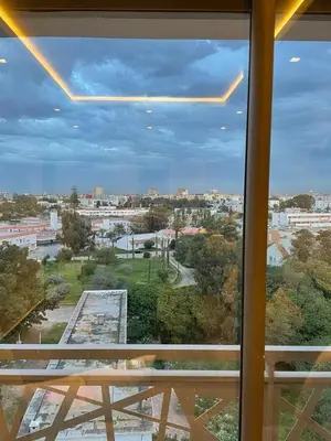a view of a city from a window at Luxury studio center Abdelmoumen 1min tram with view in Casablanca