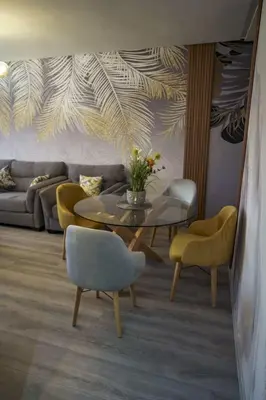 a living room with a table and yellow chairs at Relax toute l'année Piscine chauffée in Temara