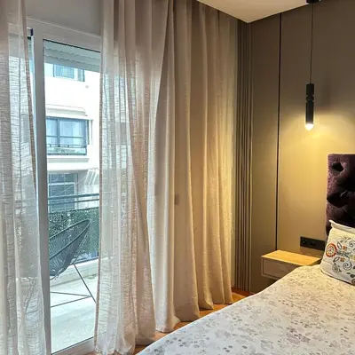 a bedroom with a bed and a large window at Appartementperle in Casablanca