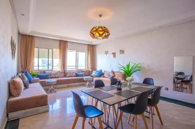 a living room with a couch and a table and chairs at Ait Ali in Casablanca