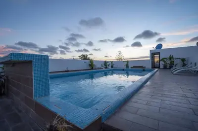 a swimming pool on the side of a house at Ait Ali in Casablanca