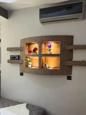 a wall with three windows with flowers on it at Elegant and Comfortable Apartment in the Heart of Rabat in Rabat