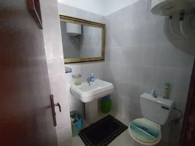 a bathroom with a sink and a toilet and a mirror at Paradis Avec Vue Harhoura in El Harhoura