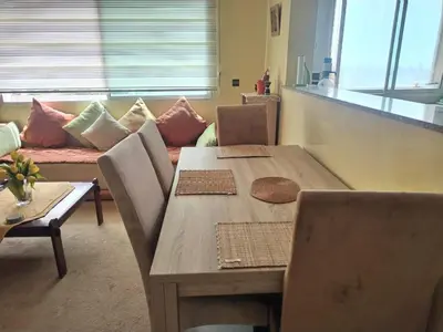 a dining room with a table and a couch at Paradis Avec Vue Harhoura in El Harhoura