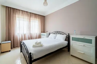a bedroom with a bed and a dresser with towels on it at Appartement Spacieux a Maarif in Casablanca